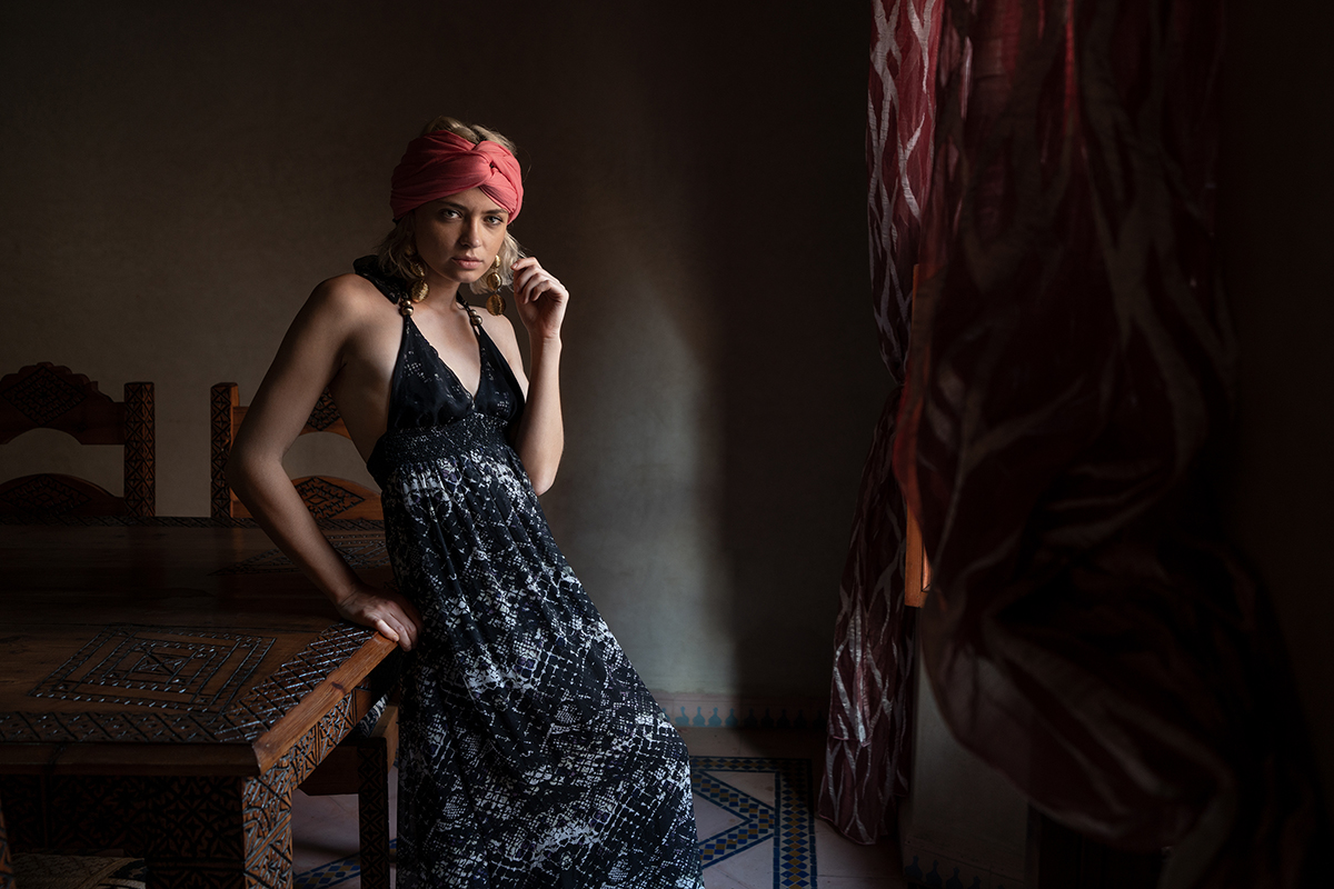 Woman next to a table by a window for natural light