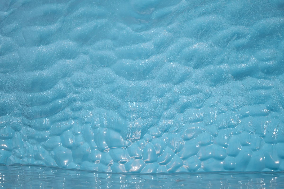 Close-up of icy blue glacier wall showing texture and detail—ideal example of focusing on patterns and surfaces using landscape photography pro tips.