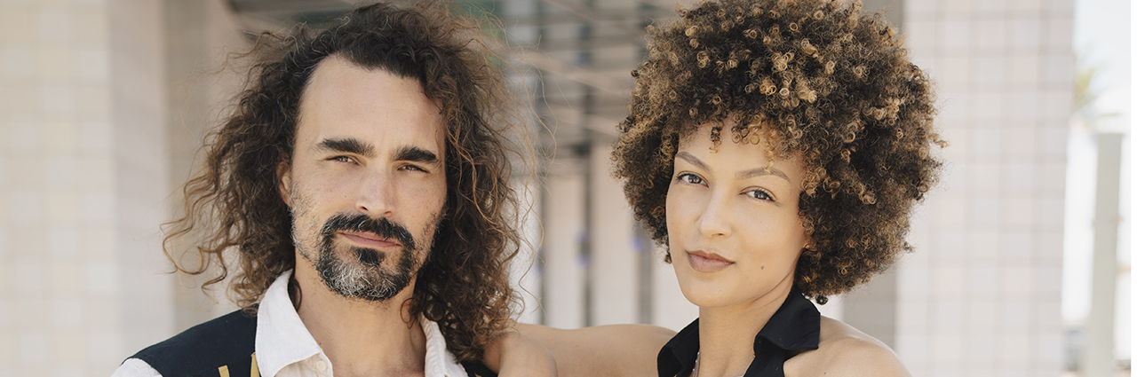 A close-up portrait of two people standing side by side shot using one of Tamron’s best camera lenses for portrait photography.