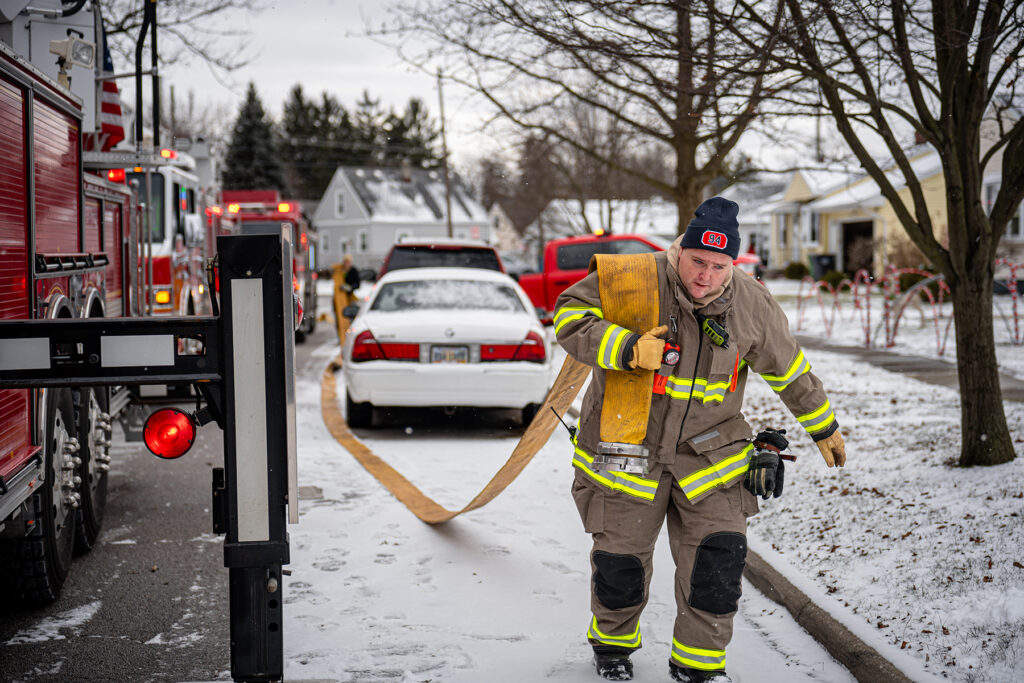 firefighter carrying hose