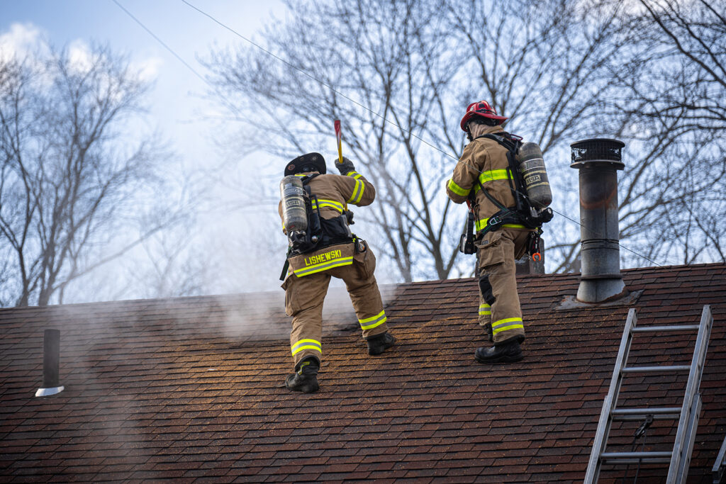 two firefighters on the roof