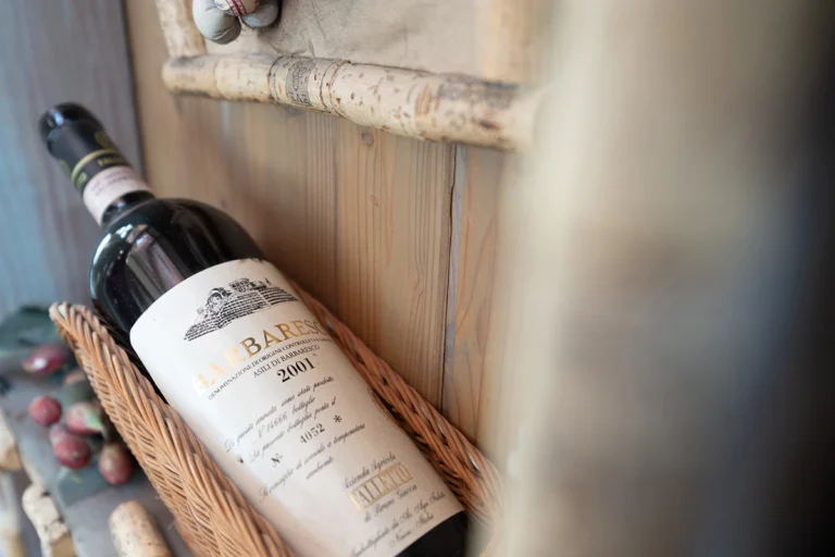A bottle of wine in a wicker holder