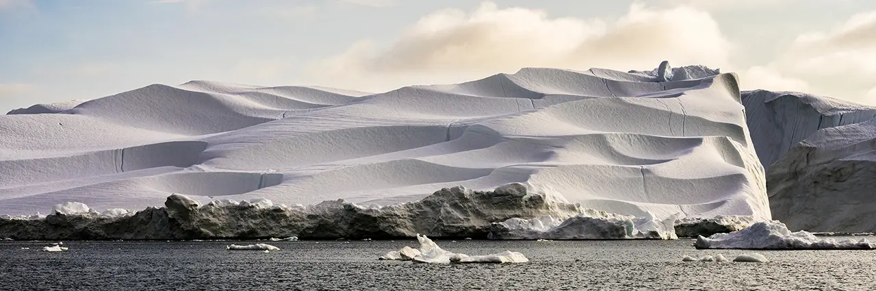 Panoramic iceberg in Disko Bay, Greenland, photographed with Tamron 28-75mm G2 lens highlighting sculpted ice patterns and Arctic light