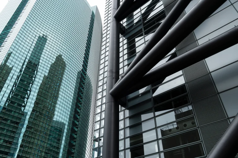 Tall city buildings made of glass and steel.