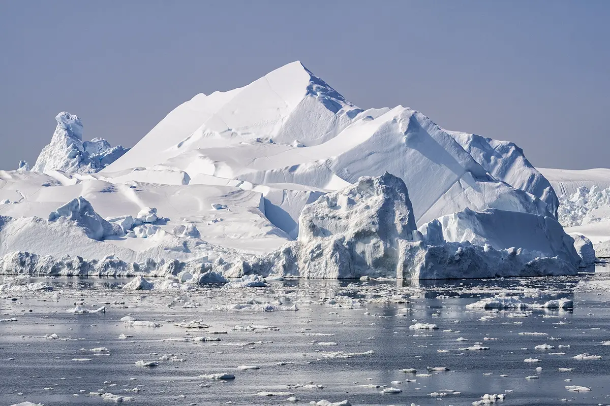 Majestic iceberg in Ilulissat Icefjord, Greenland, rising sharply above the Arctic waters and photographed with a Tamron zoom lens