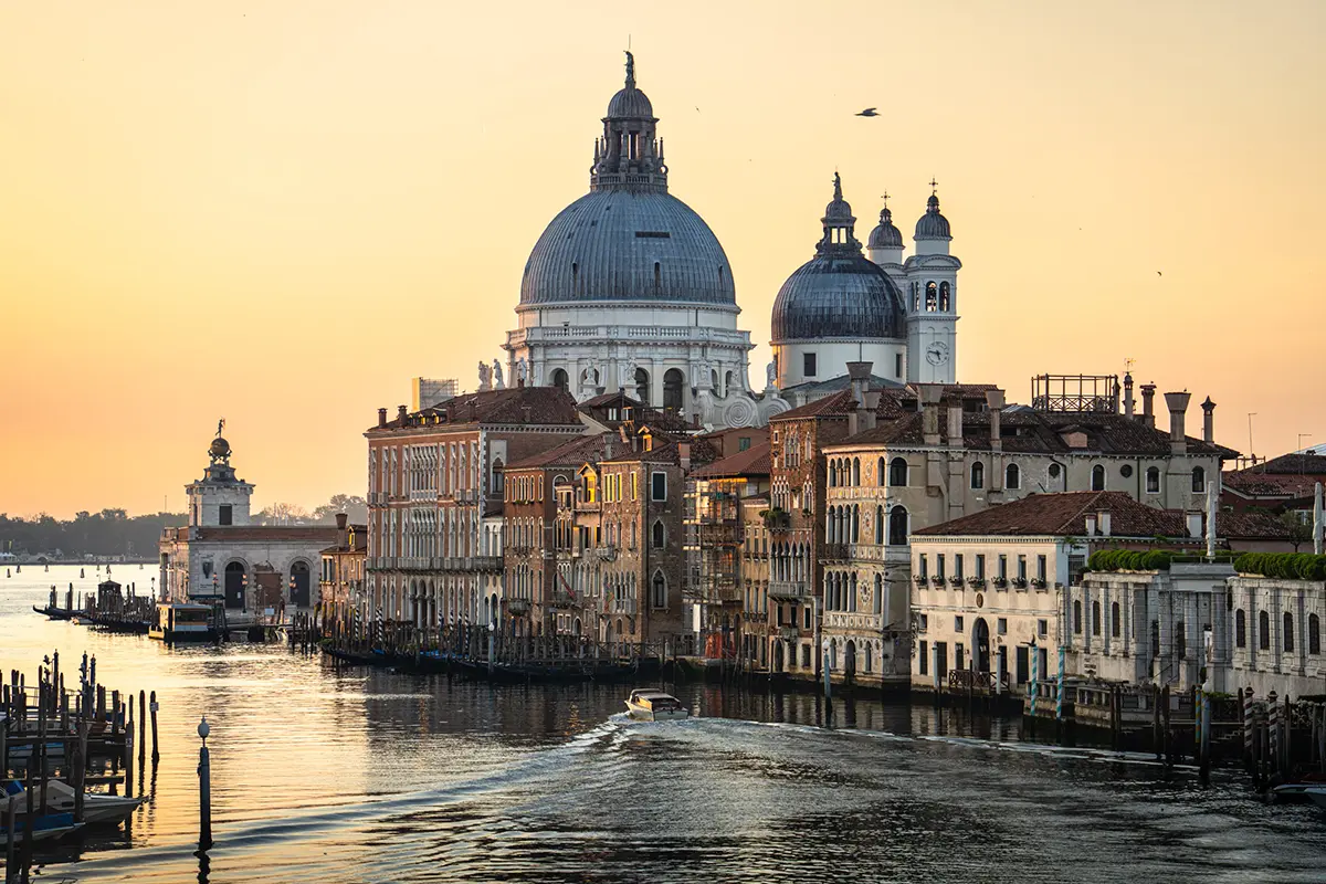 Vue de la basilique Santa Maria della Salute au lever du soleil depuis le Ponte dell'Accademia, présentée dans ce guide photographique de Venise.