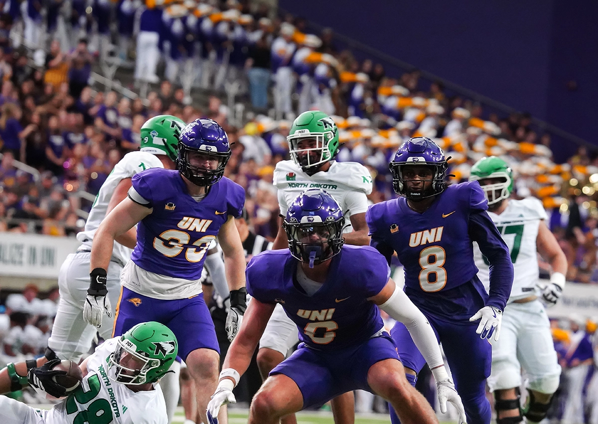 A group of footballers that just made a tackle.