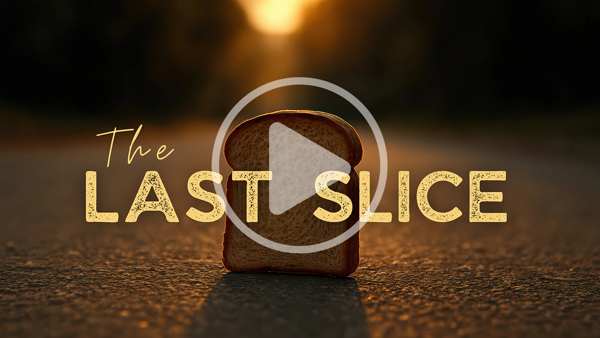 Slice of bread standing on a sunlit road with the words “The Last Slice,” demonstrating creative storytelling and lighting ideas for photographers entering photo contests.