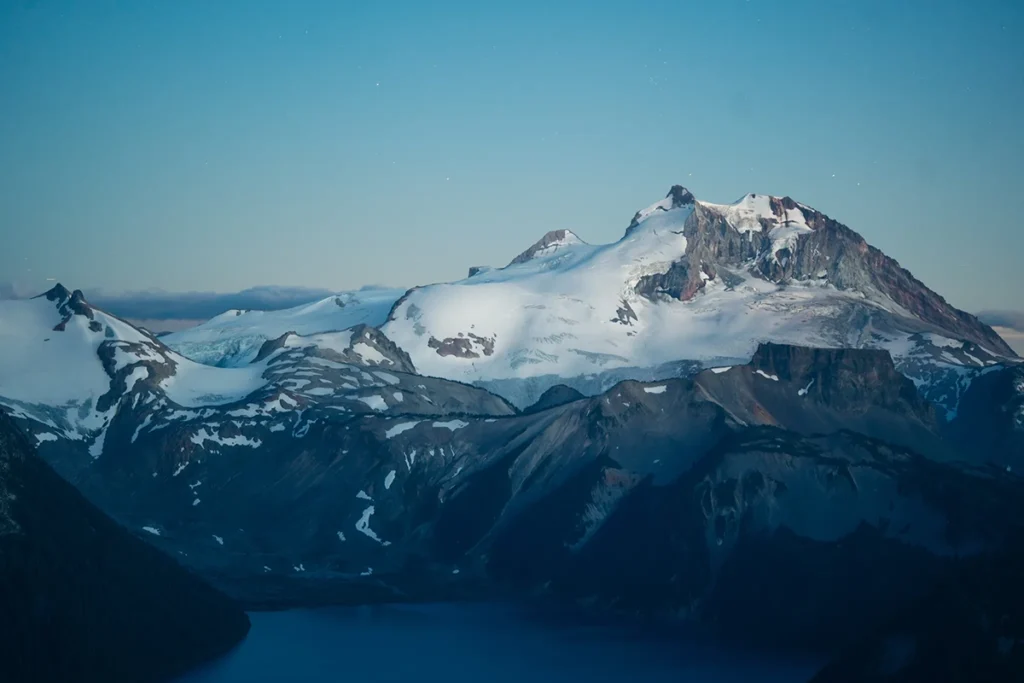 Snow-covered mountains of British Columbia photographed at dusk with the Tamron 90mm F/2.8 Di III VXD Macro lens, showing its versatility beyond outdoor macro photography.