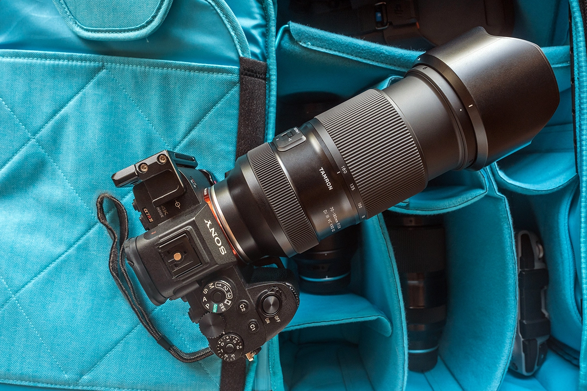 Sony mirrorless camera equipped with the Tamron 70-180mm F2.8 G2 lens placed inside a padded camera bag, showing the lens’s size, build, and travel-ready design.