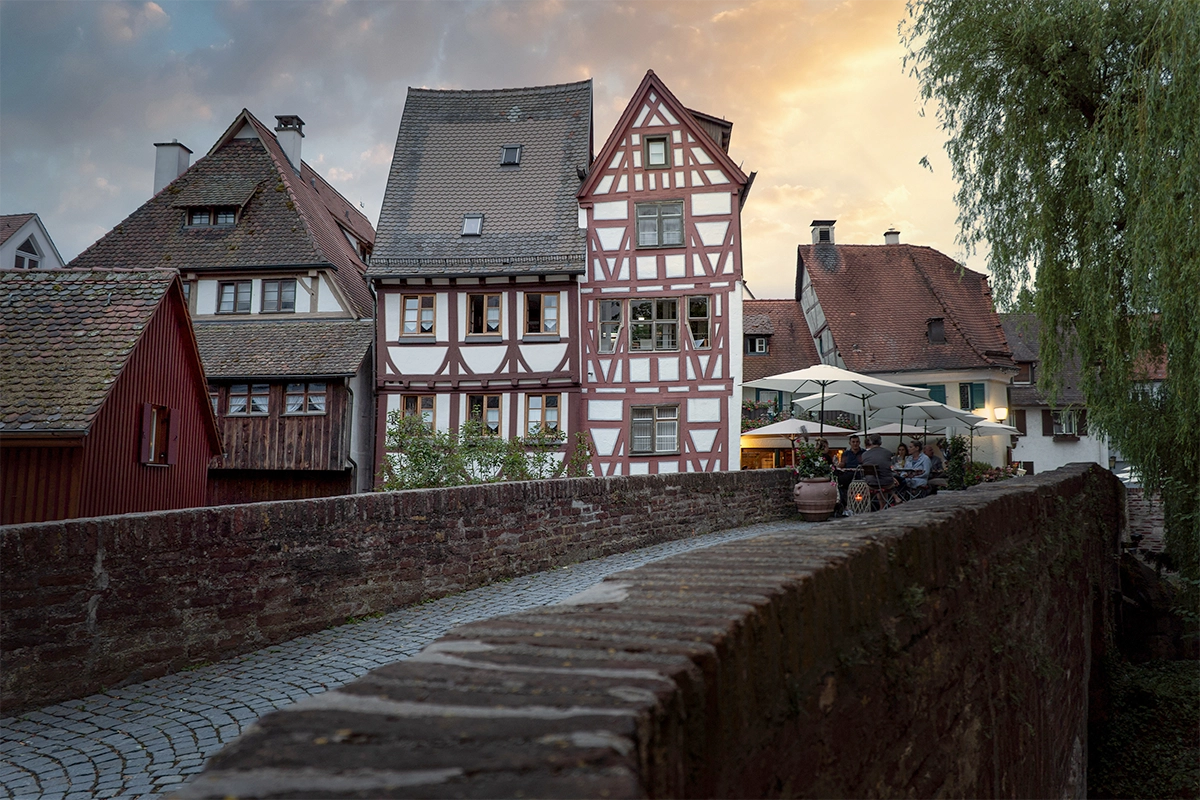 Casas tradicionales con entramado de madera en un pueblo europeo al atardecer, fotografiadas con un lente de viaje Sony con montura E para fotografía arquitectónica y de destinos.