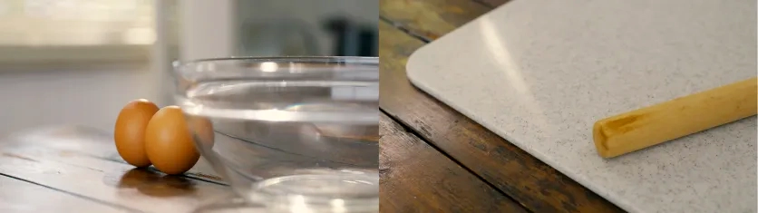 Opening shots of eggs beside a glass bowl and a rolling pin on a cutting board for the short film story setup.