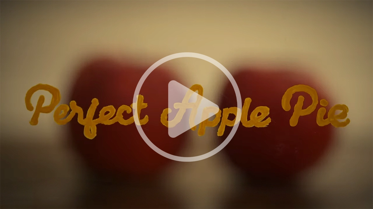 Thumbnail for “Perfect Apple Pie” short film video with warm bokeh background and handwritten title text.