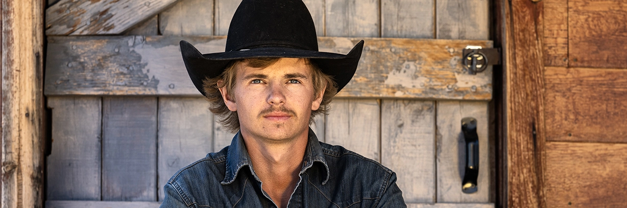 Portrait photographed with the Tamron 35-100mm F/2.8 Di III VXD lens during a natural-light cowboy workshop.