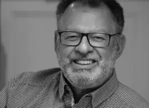 Black-and-white headshot of photographer Jacques Dumont smiling for his author bio.