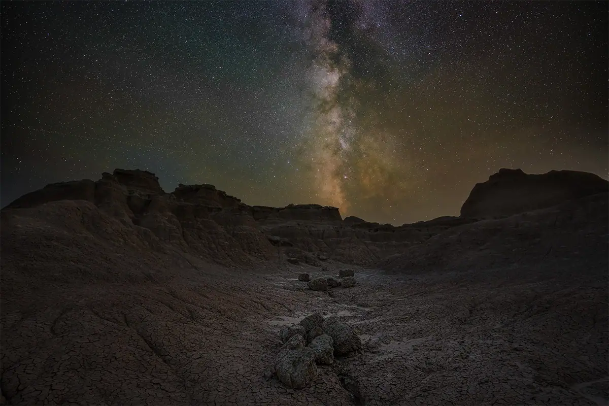 Edited Milky Way photo showing the galactic core above a Badlands nightscape.
