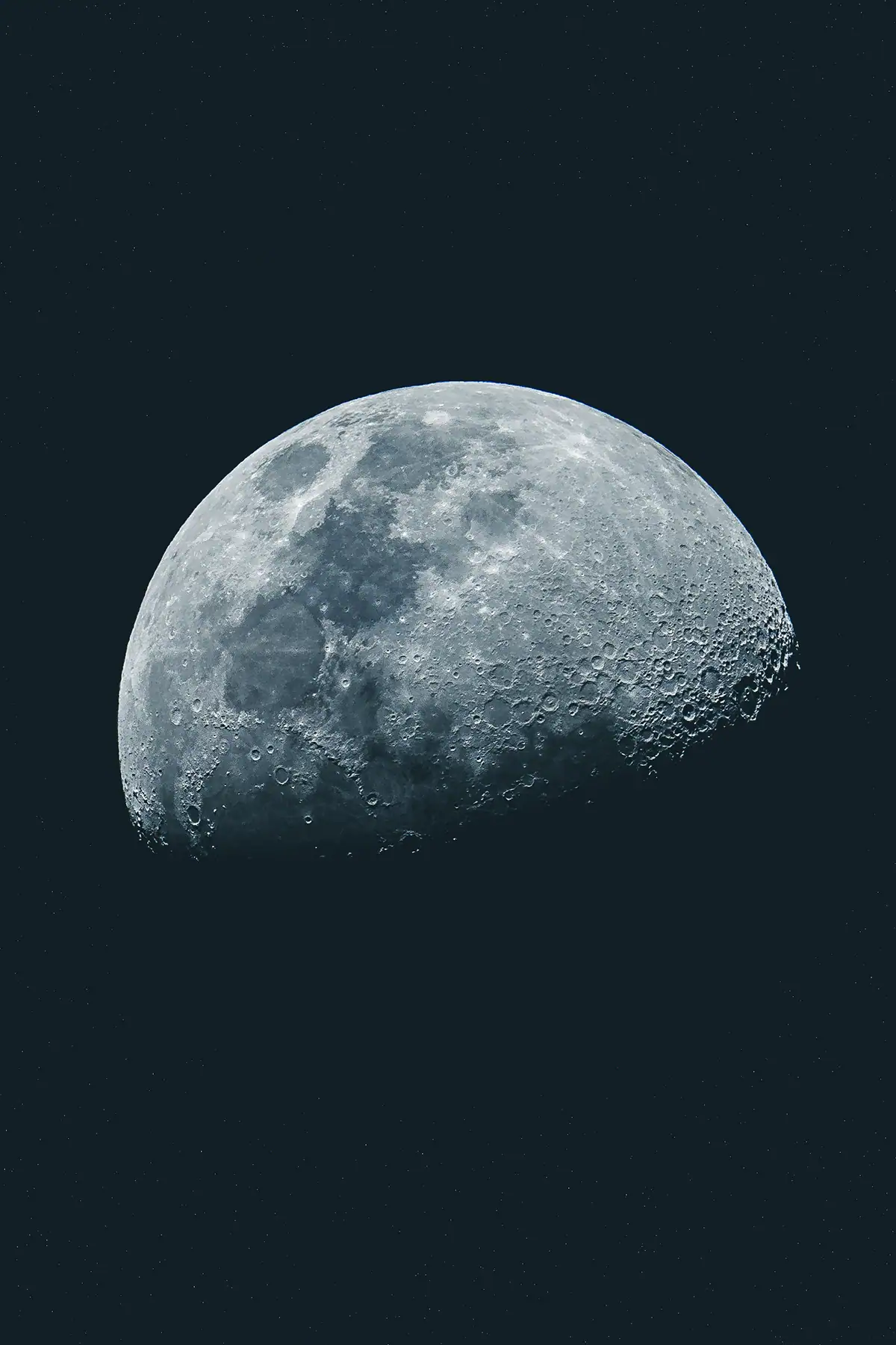 Close-up moon photograph showing craters and lunar surface detail.