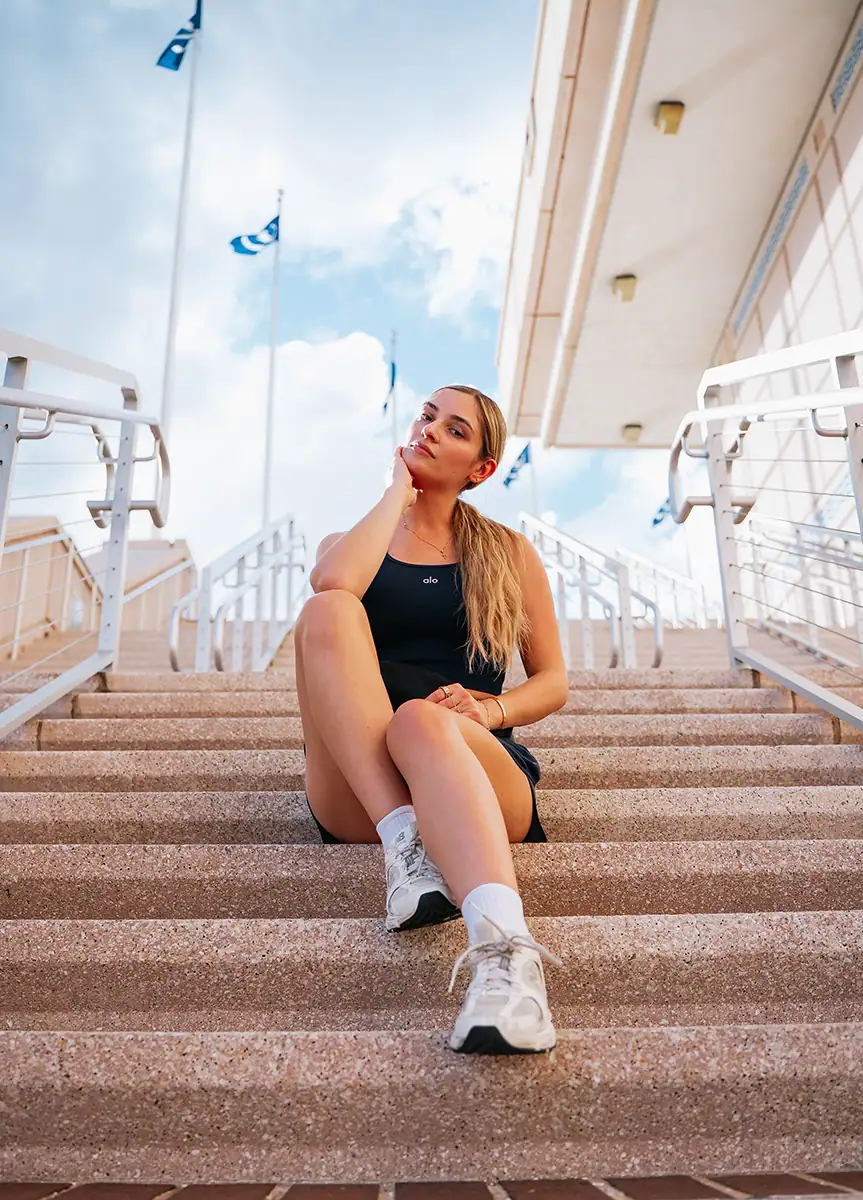 A woman sitting on the steps.