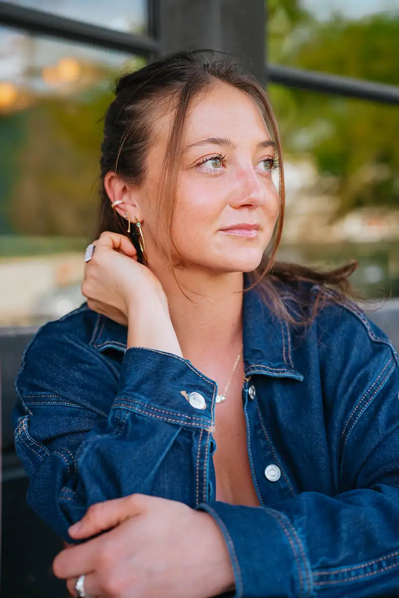 A portrait of a woman in a denim shirt.