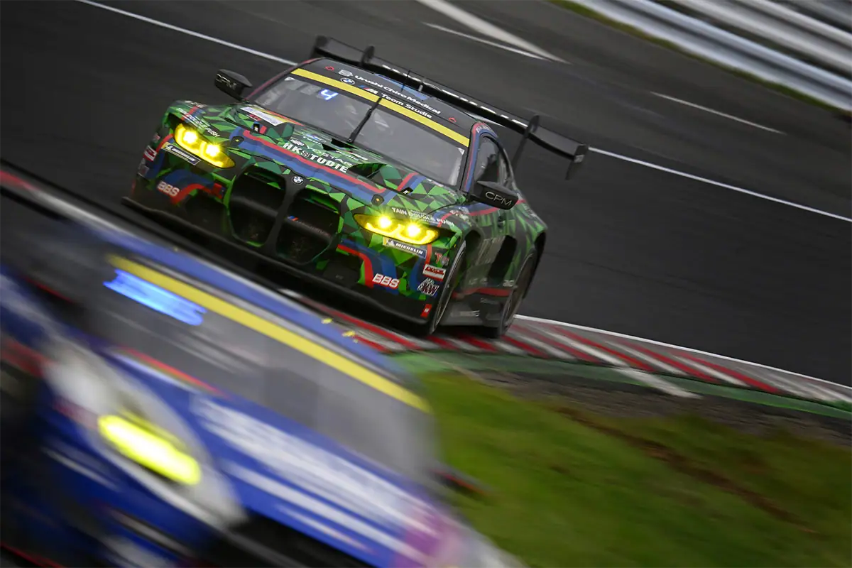 Motorsports panning photo with a sharp race car and motion-blurred background.
