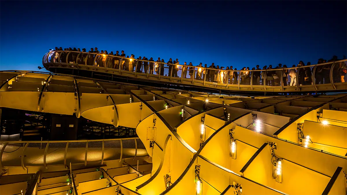 Visitors walk along the illuminated Las Setas viewpoint in Seville at twilight, photographed with the Tamron 16-30mm F2.8 G2 travel lens.