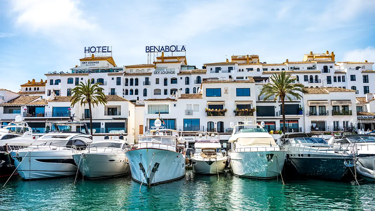 Yachts docked along the Puerto Ban&uacute;s waterfront in Andalusia, photographed with the Tamron 35-100mm F2.8 travel photography lens.