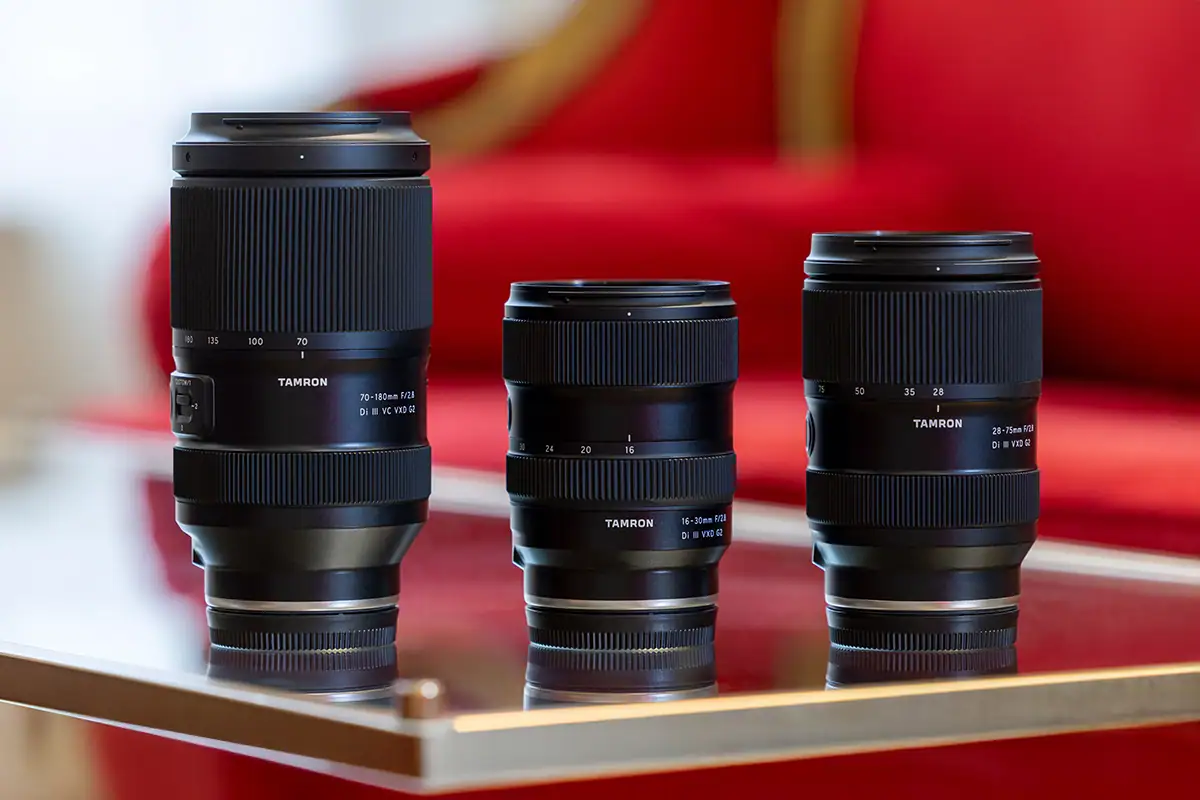 Tamron zoom lenses displayed together for wide-angle, standard, and telephoto photography.
