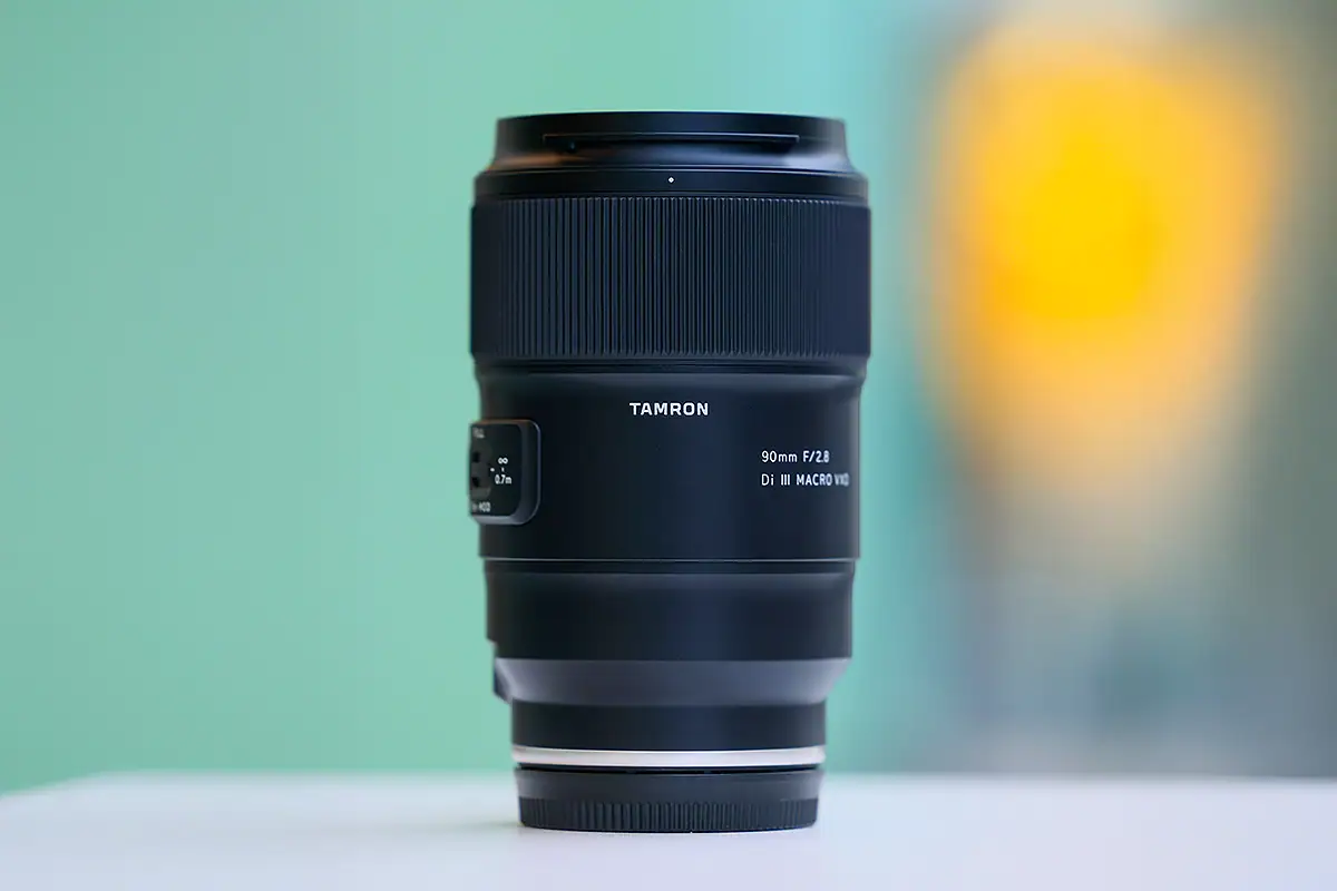 Tamron 90mm prime lens showing a fixed focal length design for portrait and macro photography.