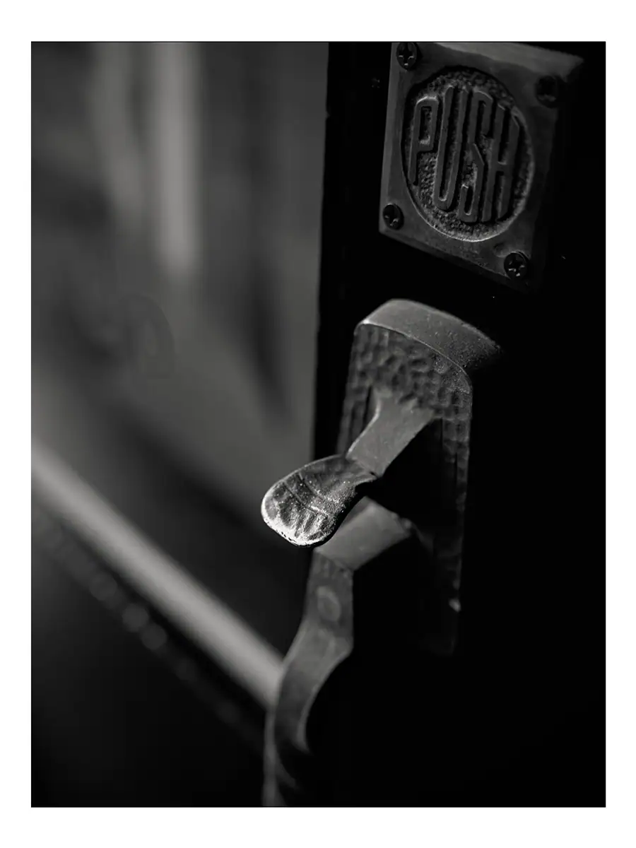 A close-up of a push down door handle
