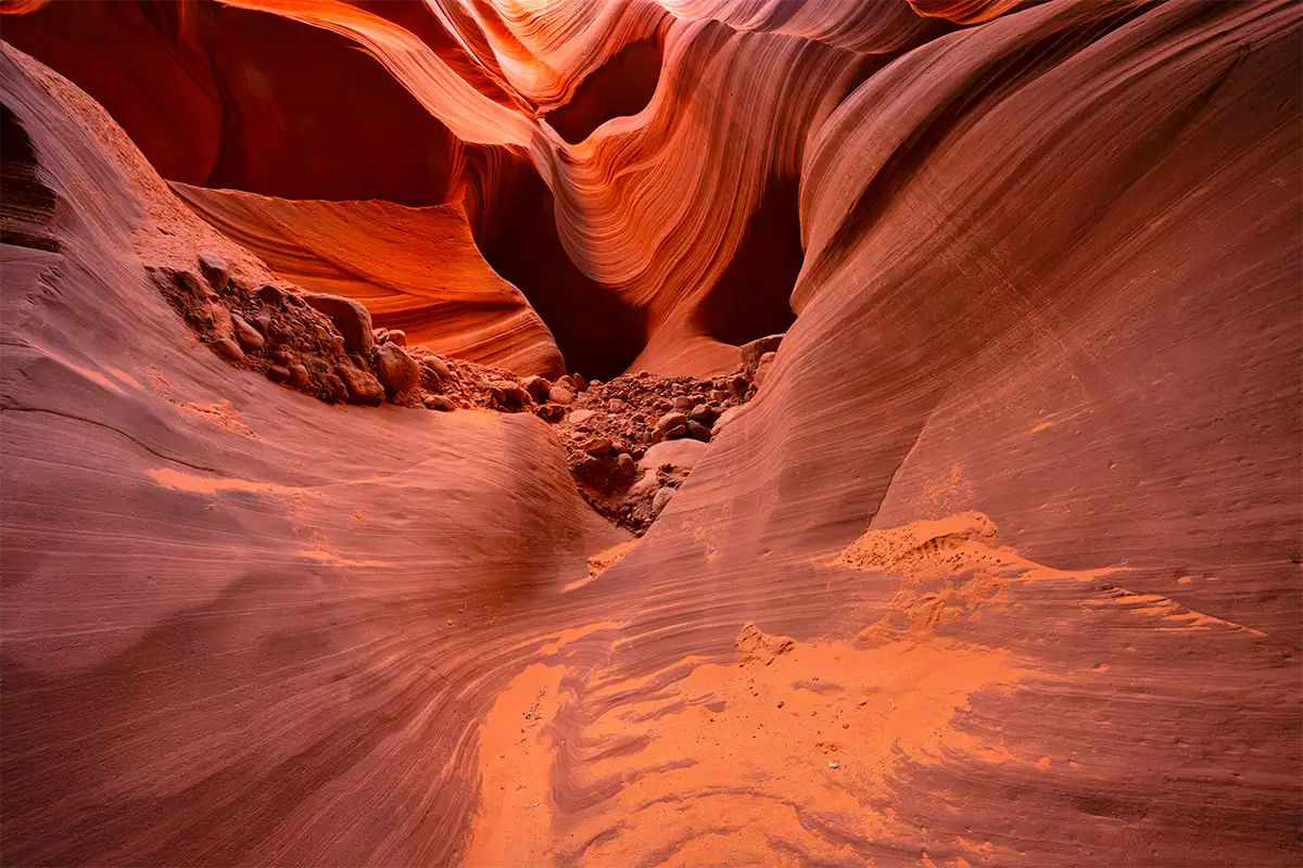 Curving red sandstone walls inside a narrow slot canyon, photographed with the Tamron 12-20mm F2.8.