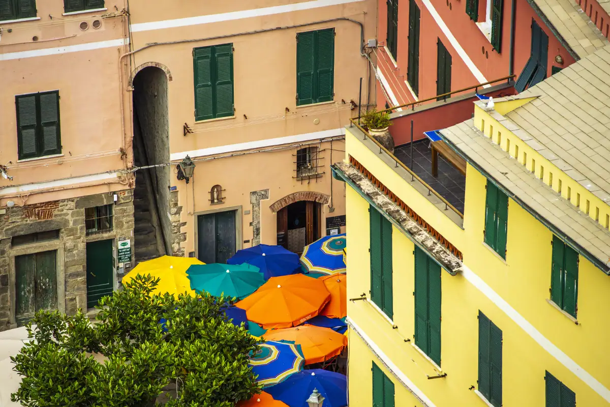 High-angle photograph looking down on colorful umbrellas and buildings, demonstrating how changing camera perspective can create a more graphic composition.