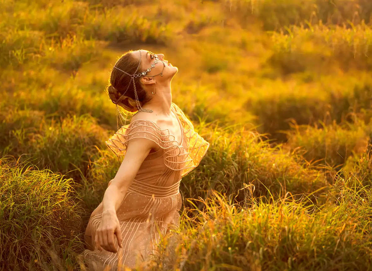 Outdoor portrait photographed in warm backlight with soft, controlled shadows and even illumination on the subject.