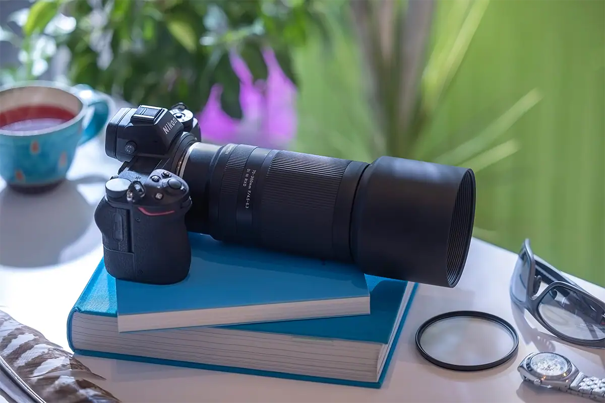 Tamron telephoto lens with a lens hood mounted on a Nikon camera to help reduce stray light and lens flare.