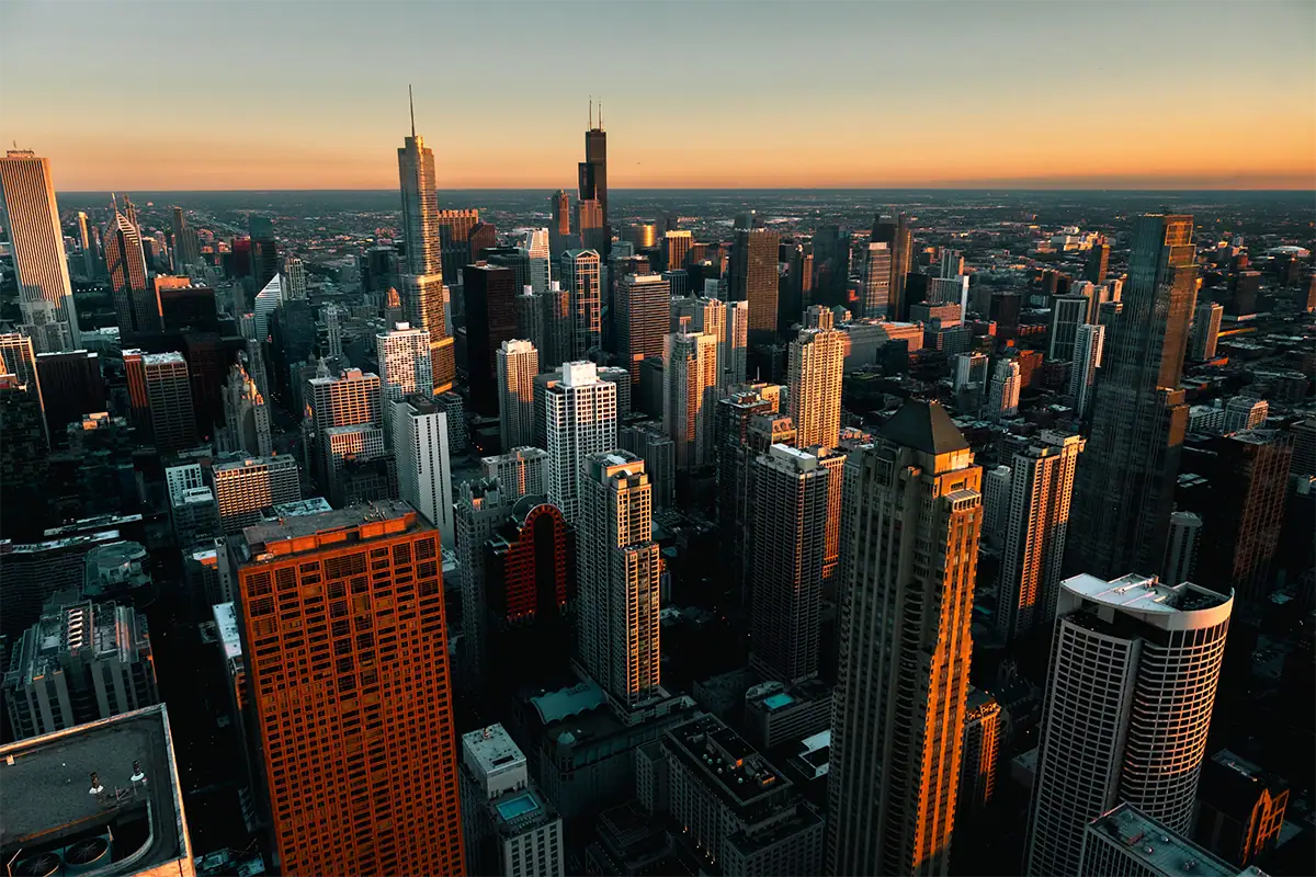 Wide sunset view of the Chicago skyline with skyscrapers illuminated by warm evening light, photographed at 16mm.