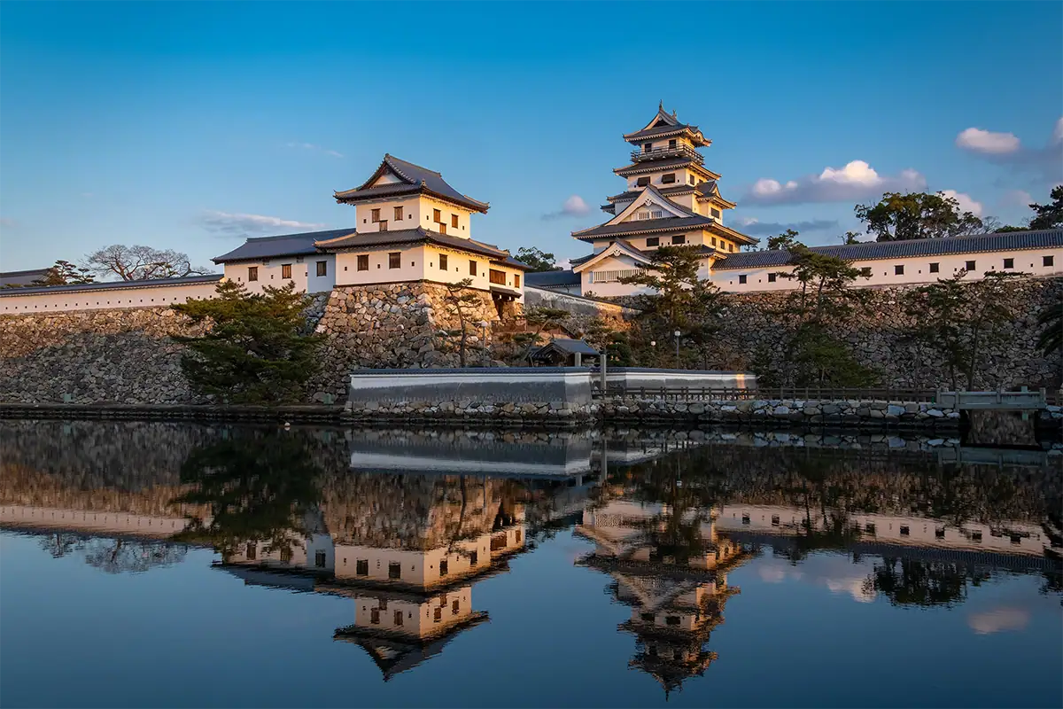 Imabari Castle reflected in its moat in Ehime, Shikoku, Japan, photographed with the Tamron 17-70mm F2.8 for Fujifilm X.