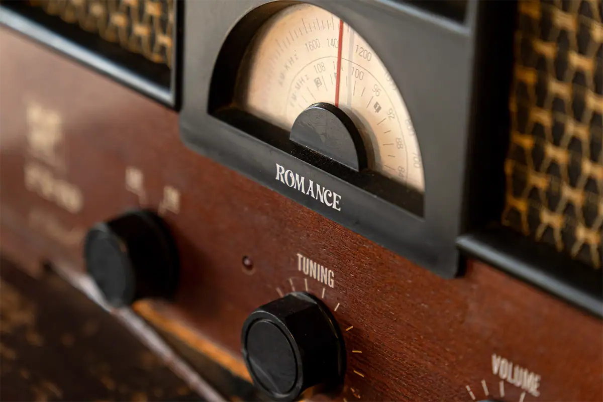 Close-up of a vintage wooden radio with an analog tuning dial, photographed with the Tamron 17-70mm F2.8 for Fujifilm X during travel in Shikoku, Japan.